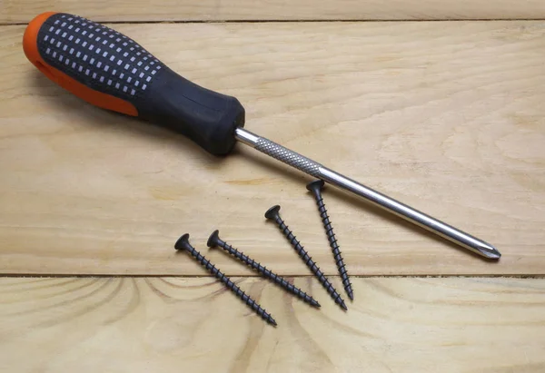 Hand screwdrivers and screws isolated on wooden background — 스톡 사진