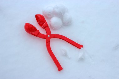 Snowball maker on the white snow. Winter holidays clipart