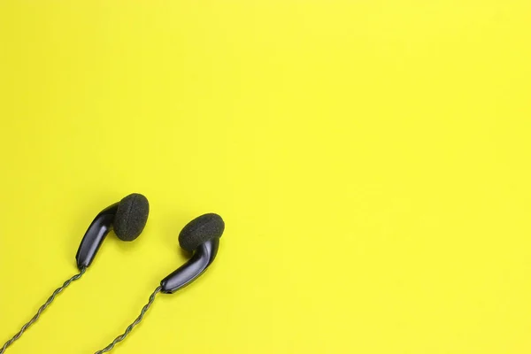 in ear headphones on blue background