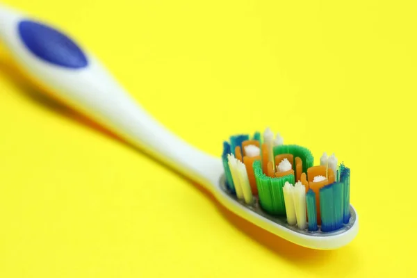 Toothbrush on yellow background close up — Stock Photo, Image