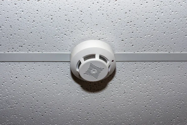 Round temperature sensor on the ceiling. Fire alarm
