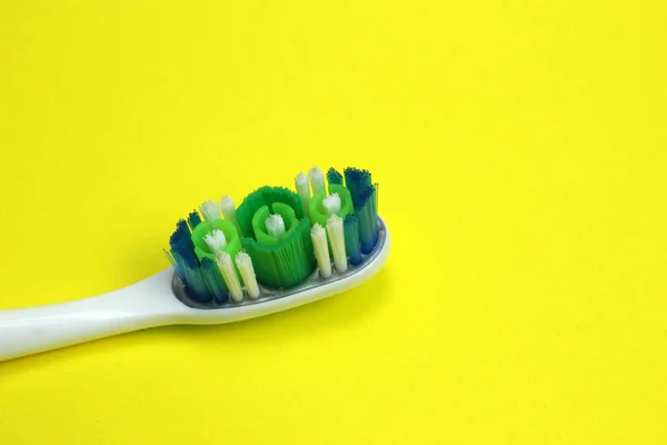 Toothbrush on yellow background close up — Stock Photo, Image