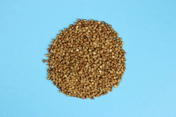 Fresh buckwheat close-up on a blue background — Stock Photo, Image