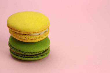 Renkli badem kurabiyeleri ya da pembe arka planda makaronlar.