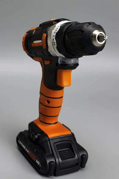Cordless drill screwdriver on a gray background — 스톡 사진
