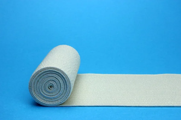 Medical bandage roll on a blue background — Stock Photo, Image