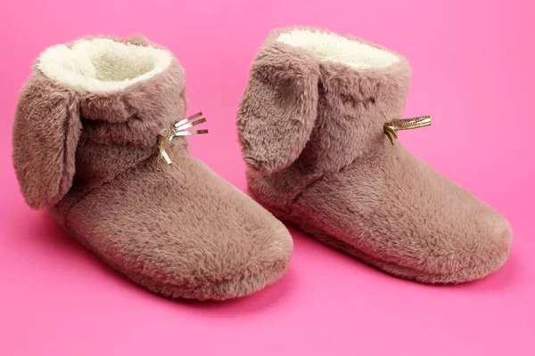 Soft fluffy Slippers with ears on a bright pink background