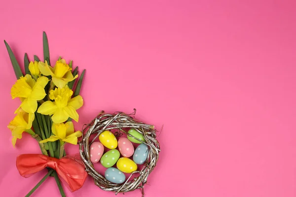 colored Easter eggs in the nest and spring flower, place for text