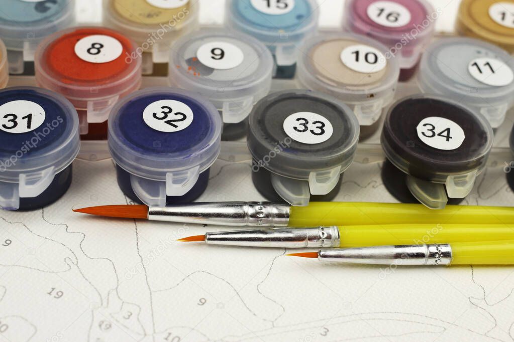 Paints and brushes for drawing pictures by numbers, copyspace