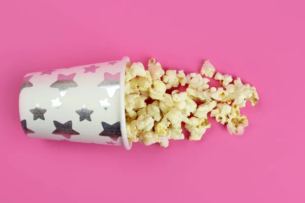 Inverted paper Cup with caramel popcorn background