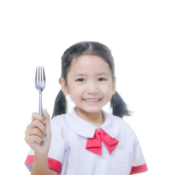 Asian little girl in Thai student uniform showing a fork Select — Stock Photo, Image