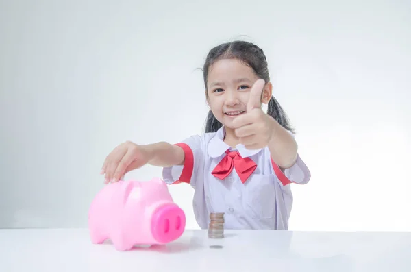 Asian little girl in Thai student uniform showing thumb up with — Stock Photo, Image