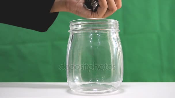 HD Falling of coins to glass jar concept to saving money with copyspace — Stock Video