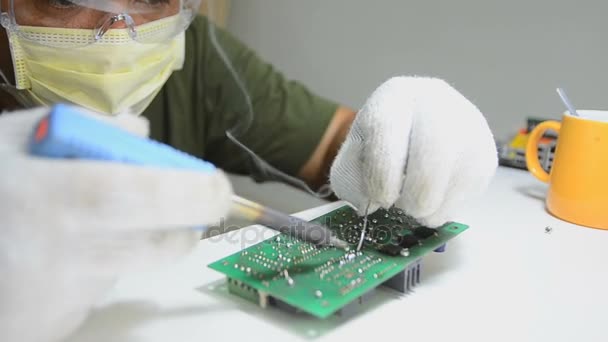 Technician is soldering to the electronic print circuit board — Stock Video