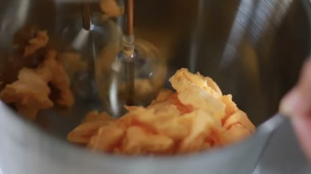 Close-up shot van de boter in een roestvrij staalkom met spinnen eten mixer — Stockvideo