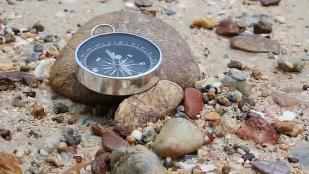 The sea waves are thrown to the shore on sand beach select focus on the rock shallow depth of field with ambient sound — Stock Video