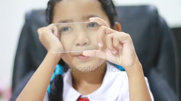 Nahaufnahme asiatisches kleines Mädchen in thailändischer Kindergartenuniform mit Cleas-Glas wie Smartphone für futuristische Cyber-Technologie Netzwerkverbindungskonzept — Stockvideo