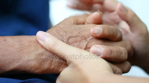 Hands of young woman holding and gentle touch to Hands of old women metaphor and concept for love inspiration soothe and hope of family old mother and young daughter — Stock Video