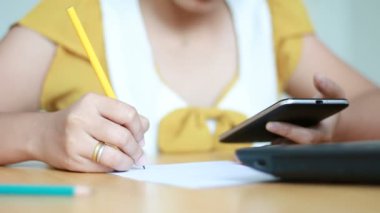 Telefon kullanan kadın elinde telefon akıllı ve yazma kağıt metafor online başvuru ve el sığ derinlik-in tarla seçin odak pazarlama iş kalem