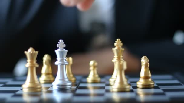 Close up shot hands of man and business woman moving gold king chess to kill silver king chess on chess board game for winner and loser business challenge metaphor and business competition concept with ambient sound — Stock Video