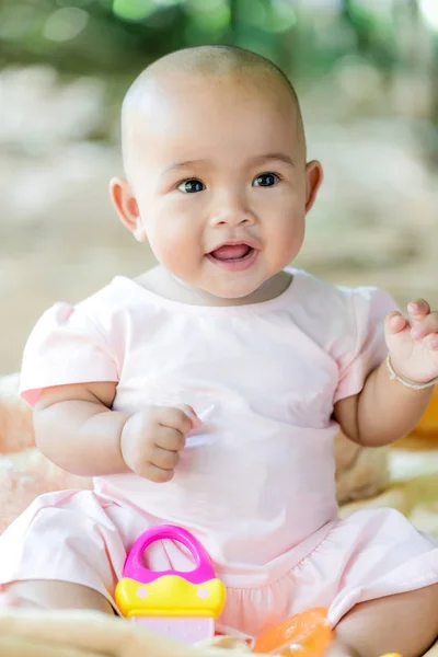 Cute little Asian baby sitting and play with happiness select fo — Stock Photo, Image