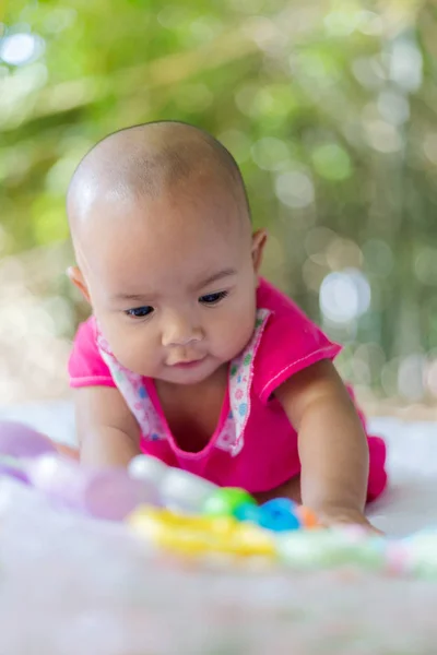 Cute little Asian baby sitting and play with happiness select fo — Stock Photo, Image