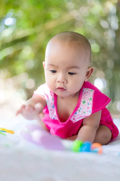 Cute little Asian baby sitting and play with happiness select fo — Stock Photo, Image