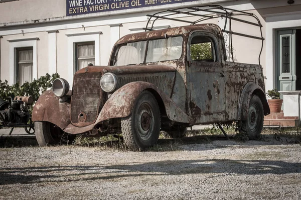 abandoned rusty car stands alone stands in a parking lot