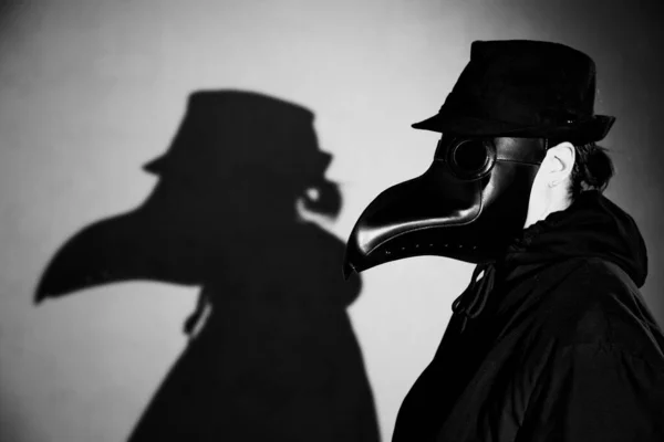 Actress in the mask of the plague doctor.