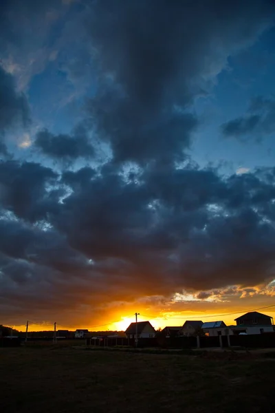 Sunset in the sky over the country settlement, Moscow region, Russia.