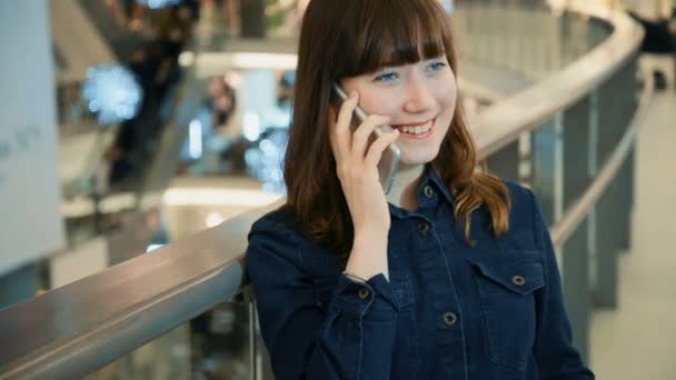 Vrouw praten over de telefoon in het winkelcentrum — Stockvideo