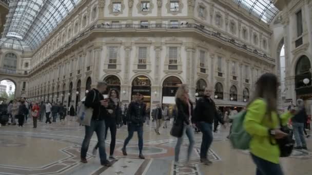 МИХАИЛ (ИТАЛИЯ) - Пятеро человек совершают покупки в миланской галерее Витторио Эмануэле II. Галерея является старейшим торговым центром Италии, построенным между 1865 и 1877 годами . — стоковое видео