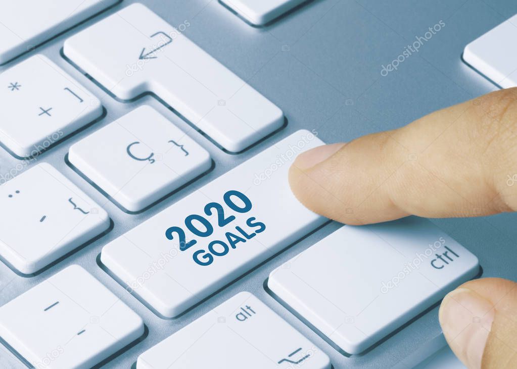 2020 Goals - Inscription on Blue Keyboard Key. 2020 Goals Written on Blue Key of Metallic Keyboard. Finger pressing key.