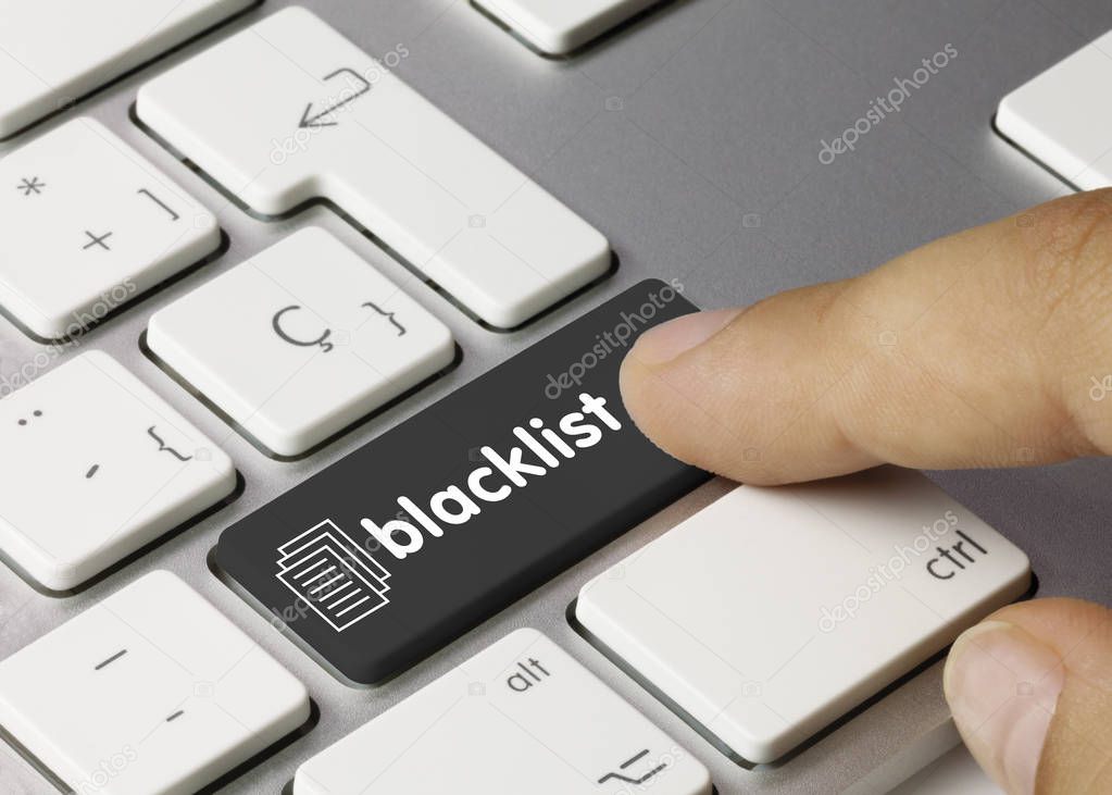 blacklist - Inscription on Black Keyboard Key. blacklist Written on Black Key of Metallic Keyboard. Finger pressing key