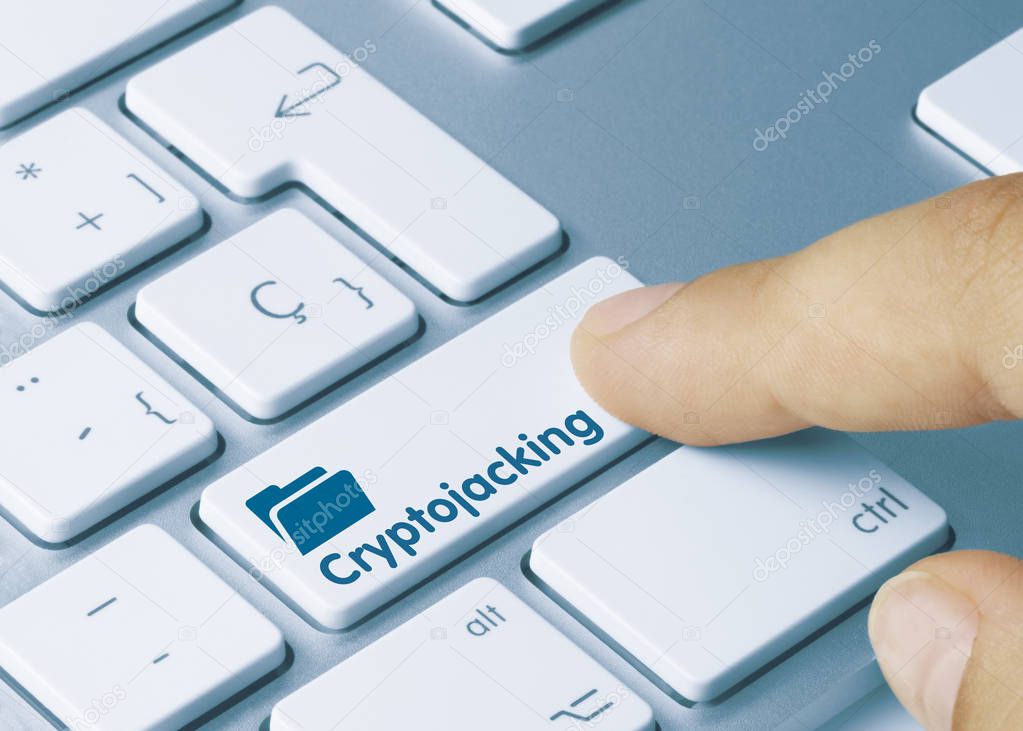 Cryptojacking - Inscription on Blue Keyboard Key. Cryptojacking Written on Blue Key of Metallic Keyboard. Finger pressing key.