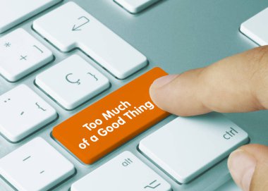 Too Much of a Good Thing - Inscription on Orange Keyboard Key. Too Much of a Good Thing Written on Orange Key of Metallic Keyboard. Finger pressing key. clipart