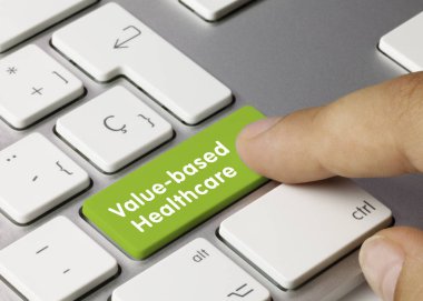 Value-based healthcare - Inscription on Green Keyboard Key. Value-based healthcare Written on Green Key of Metallic Keyboard. Finger pressing key. clipart