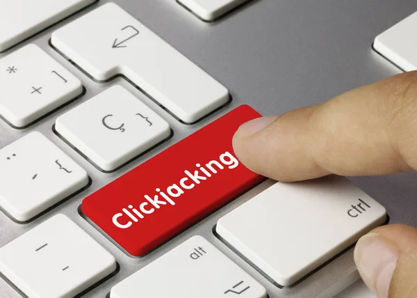 Clickjacking - Beschriftung auf roter Tastatur. — Stockfoto