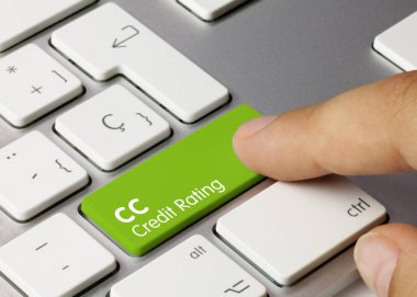 CC Credit rating Written on Green Key of Metallic Keyboard. Finger pressing key. clipart