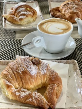 italian breakfast for two coffee with hearts and croissants