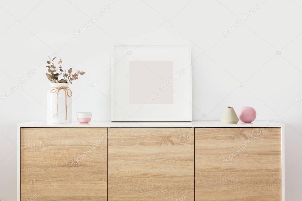 Empty square white frame in living room interior with nordic decoration