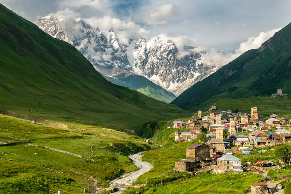 Ushguli village at sunset with Shkhara mountain in the background.