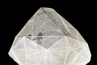 Naoshima, Japan - October 24, 2018: Sou Fujimoto's naoshima geometric pavilion illuminated by night with two silhouettes inside.