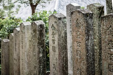 Nara, Japan - October 23, 2018: Row of Buddhist obelisks near Todai-ji temple in Nara, Japan.