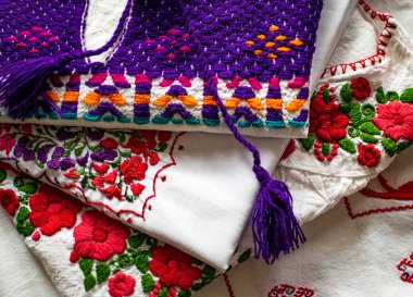 Traditional Mexican embroidered woman blouses with colorful floral motives.