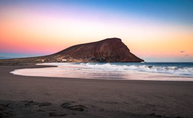 Colorful sky after sunset at La Tejita beach with the iconic 