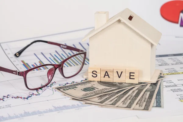 Miniature house with money and chart — Stock Photo, Image