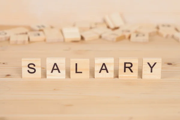 Salary word written on wood cube