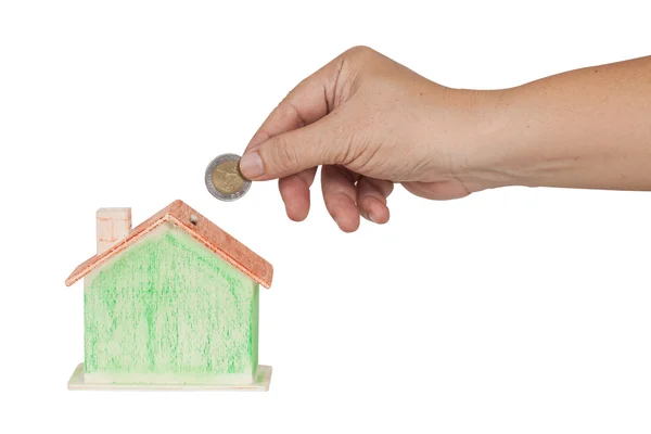 Hand push a coin in to money box concept for mortgage or real — Stock fotografie