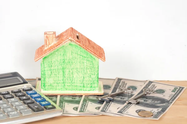 Miniature house with money and office supplies — Stock Photo, Image